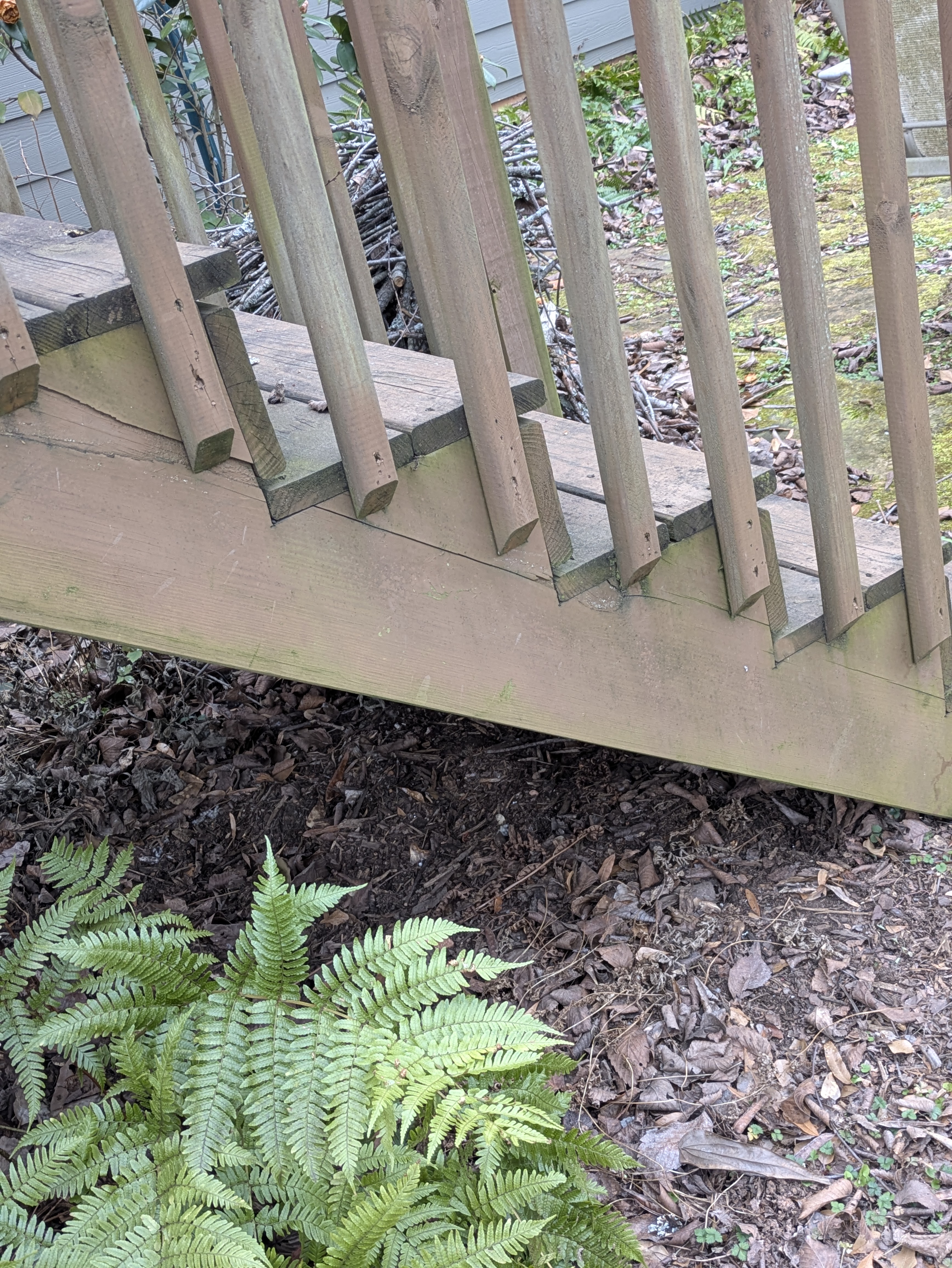 Repairing wooden deck railings on a Normaltown cottage